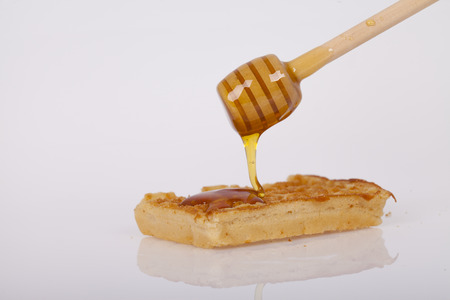 Cookie topped with honey on a light backgroundの写真素材