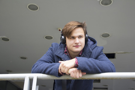 Young man listens to music, Selective focus and small depth of field, lens flareの写真素材