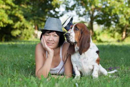 The woman with a dog in the park, Selective focus and small depth of field, lens flareの写真素材