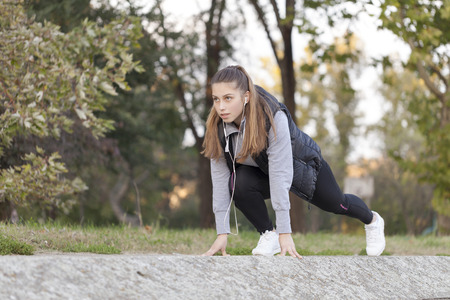Beautiful young woman running in the park, Selective focus and small depth of field, lens flareの写真素材