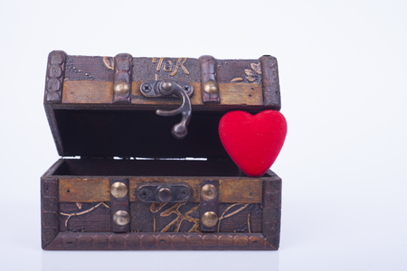 Red heart in a wooden box on a white backgroundの写真素材