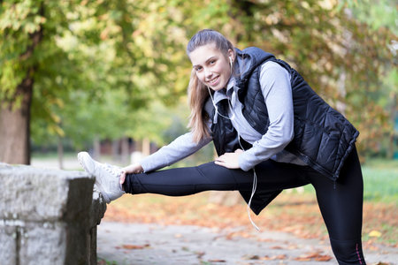 Beautiful young woman running in the park, Selective focus and small depth of field, lens flare