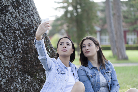 Young woman phoning with a mobile phone, Selective focur and small depth of field, lens flareの写真素材