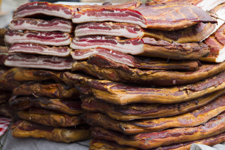 Home made smoked bacon in a street market, selective focus and small depth of fieldの写真素材