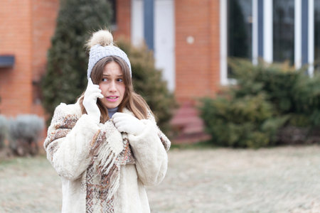 Young woman phoning with a mobile phone, Selective focus and small depth of fieldの写真素材