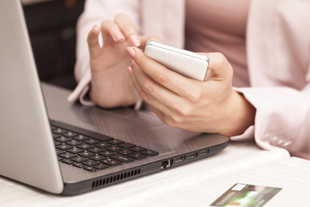 Young business woman phoning in his office, Close up, Selective focus and small depth of fieldの写真素材
