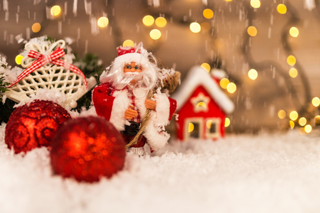 Christmas decoration on a wooden background with Santa Claus, snow and lights in the background. Happy New Year.の写真素材