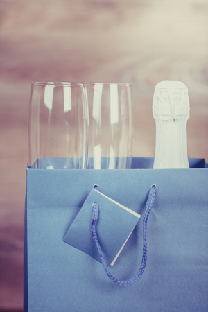 Valentines Day. Champagne and  wine glasses in paper bag. Appointment, Birthday. Concept: happiness, holidayの写真素材