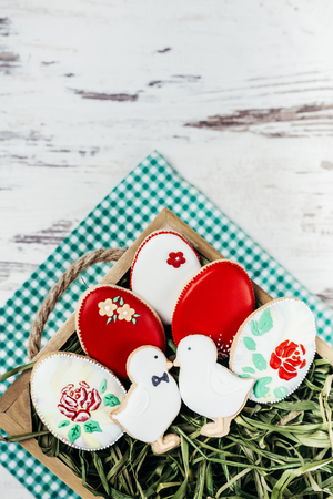 Beautiful glazed easter gingerbread cookies eggs on wooden table. Greeting card. View from above.Copy space.の写真素材