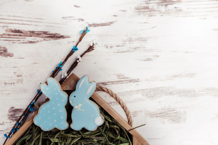 Easter gingerbread cookies on wooden table. Beautiful glazed rabbits. Greeting card. View from above.Copy space.の写真素材