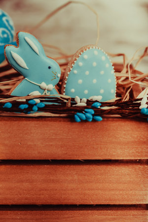 Close up beautiful glazed easter gingerbread cookies on wooden table. Rabbit and egg. Greeting card....