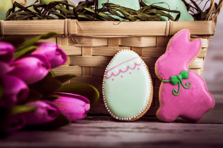 Easter gingerbread cookies on wooden table. Rabbit and egg. Greeting card. View from above.Copy...