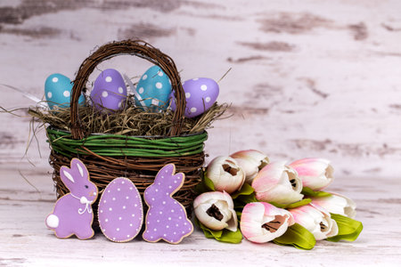 Easter gingerbread cookies and flower decoration on wooden table. Rabbits and eggs. Greeting card....