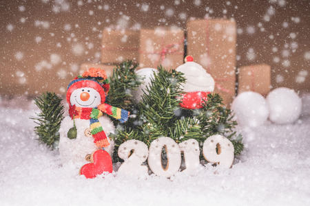 Snowman with gingerbread and Christmas decorations. Merry Christmas and Happy New Year 2019.の写真素材
