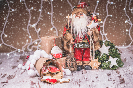 Santa Claus with gingerbread, Christmas decorations and snow. Merry Christmas and Happy New Yearの写真素材