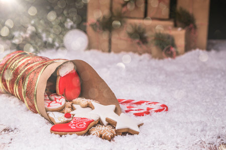 Christmas gingerbread and christmas decorations on wooden background with snow. Copy space.の写真素材