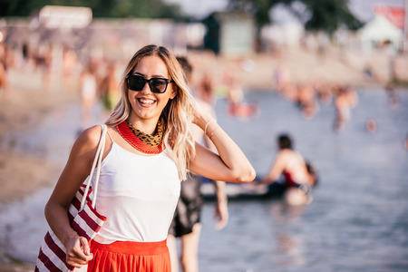 Beautiful and happy woman, girl on beach have fun and relax on summer vacation over the seaの写真素材