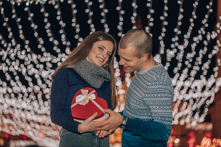 Man giving a gift to his girlfriend for Valentines day. - Imageの写真素材