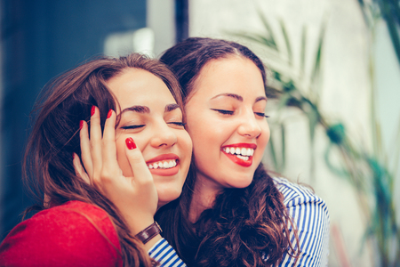 Happy lady hugging best friend, sitting in a cafe, having pleasant talk - Imageの写真素材