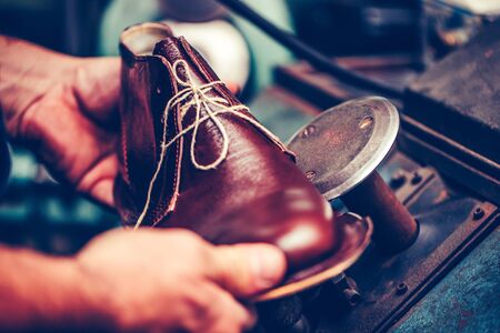 Experienced shoemaker using special machine tool for making a shoes The process of making shoes.の写真素材