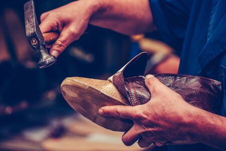 Shoemaker workshop for making shows artisan handmade manufacturing leather shoes. Shoe manufacture business for traditional vintage shoe making, craft shoes in traditional styleの写真素材