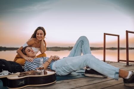 Shot of a young couple having a romantic date by the riverの写真素材