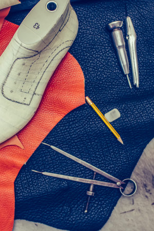 Shoemaker's work desk. Tools and leather at cobbler workplace. Shoes, leather, shoemaking tools and...