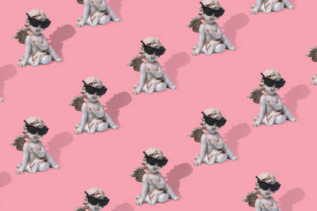 Minimal creative idea with a white angel in sunglasses, pattern on a trendy pastel color background. Funny art design.の写真素材