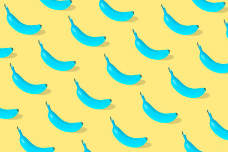 Trendy Summer pattern made with fresh banana fruit colored in blue on illuminating yellow...