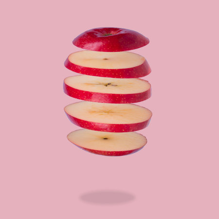 Floating levitating ripe apple on pink background. Vitamins, healthy diet concept. Minimal fruit...