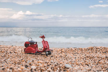 Vintage miniature motorcycle on summer background. Vacation, trip, travel, weekend, holidays concept.の写真素材