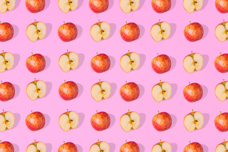 Outstanding pattern of fresh whole apples  and apple halves on a pink  background. Minimalist...