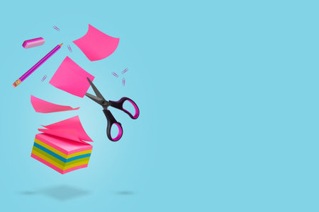 Creative idea made of notes, pieces of paper, pencil, eraser and scissors floating in the air....