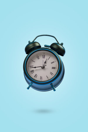Minimal scene with an alarm clock floating in the air on a blue background. Creative concept of...