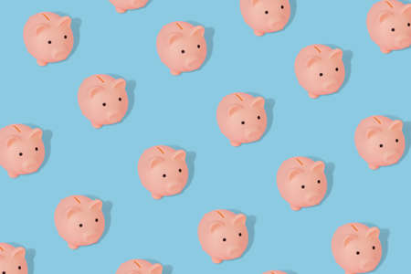 Cute pattern with a piggy banks on a blue background. Modern minimal design art for poster, banner and print.の写真素材