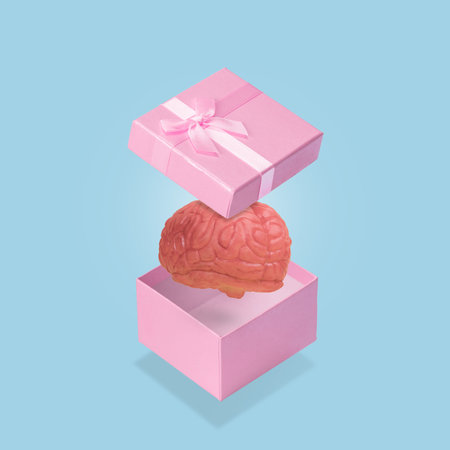 Open pink gift box with a human brain. Funny and creative minimal idea. Knowledge as a gift. Copy...