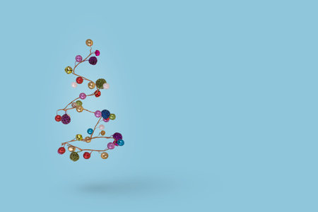 Christmas tree made of colorful  balls on a blue background. Minimal New Year and Holiday concept.