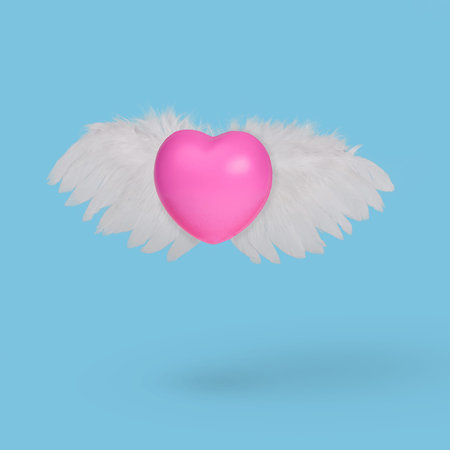 Gently pink flying heart on a blue background. Heart with angel wings. Valentine's day postcard. Minimal love concept.の写真素材