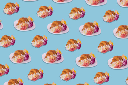 Creative pattern made of freshly baked croissant with flowers on bright blue background. Minimal...