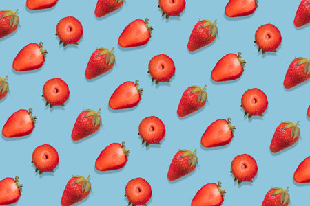 Strawberry pattern on a  bright blue background, creative flat lay healthy food concept, top view.の写真素材