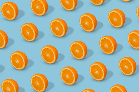 Fresh sliced orange on bright blue background. Fruit pattern, creative summer concept. Pop art design, creative summer concept.の写真素材