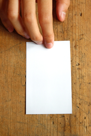 white blank name card on wood backgroundの写真素材