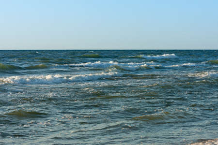 late evening at the Baltic Sea, the sun reflects on the wavesの写真素材