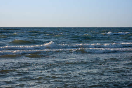 late evening at the Baltic Sea, the sun reflects on the wavesの写真素材