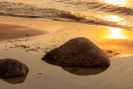 large stone on the sandy seashoreの写真素材
