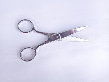 sharp stainless steel metal scissors on a white backgroundの写真素材