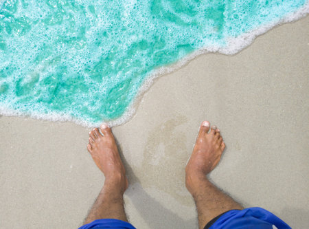 feet on beach, vacation on beach with bare feet standing on the clear white sandy beach, Asian man...