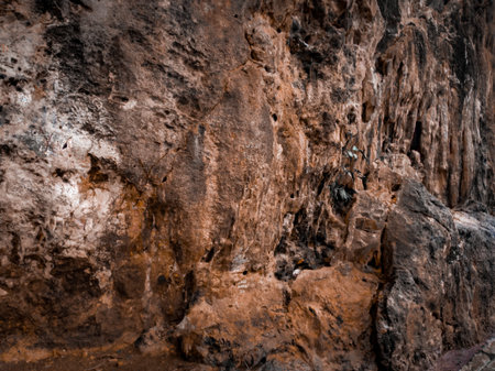 texture of the side of a mountain cliff and overgrown with grass. Hill cliff stone texture...