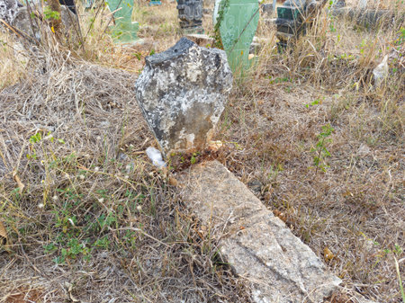 tombstones filled with dry grass. focus on the gravestone