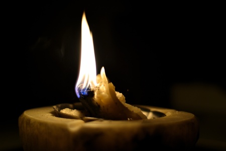 Burning candle in darknessの写真素材